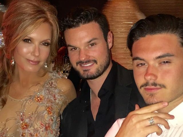 About the picture, Tracey is wearing well designed dressed and both her son is wearing black coat with black shirt and white shirt.